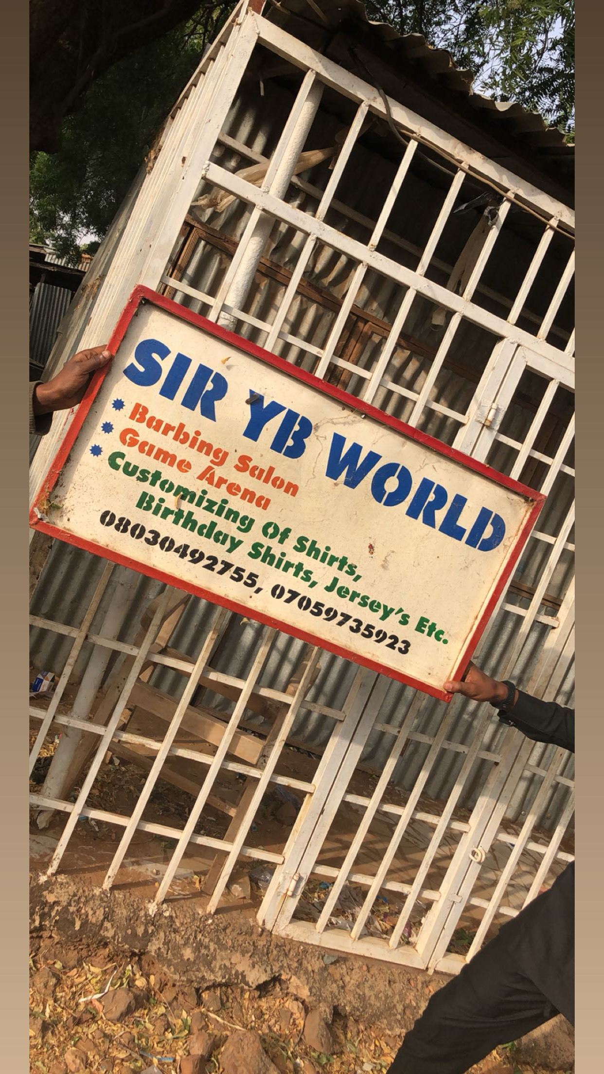 Original Sir YB World sign outside the early UDUS campus shop